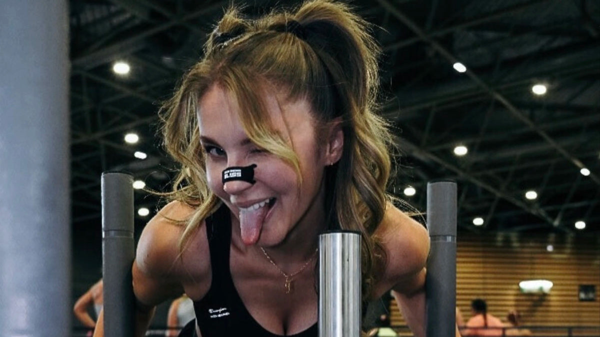 An athlete wearing a BreathersBliss nasal strip during training